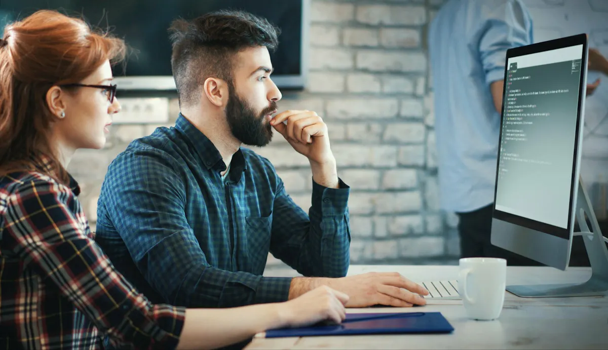 Woman and man learning coding skills